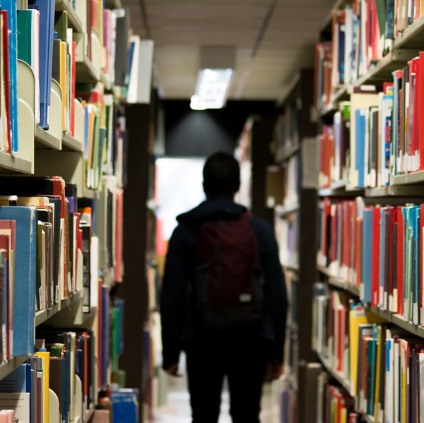 A photo of a person's silhouette in a library